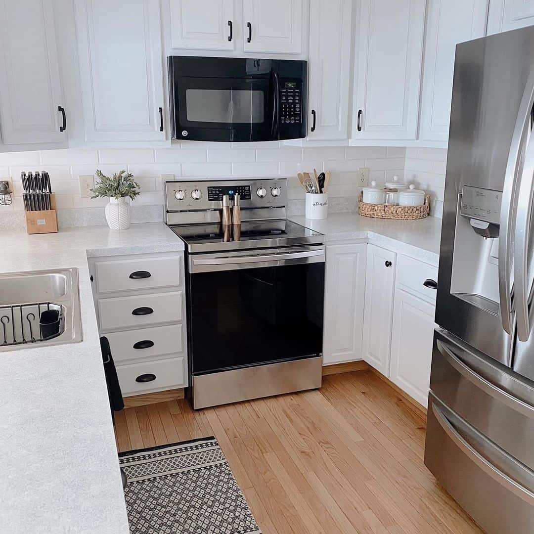 U-Shaped Kitchen with White Subway Tile Backsplash