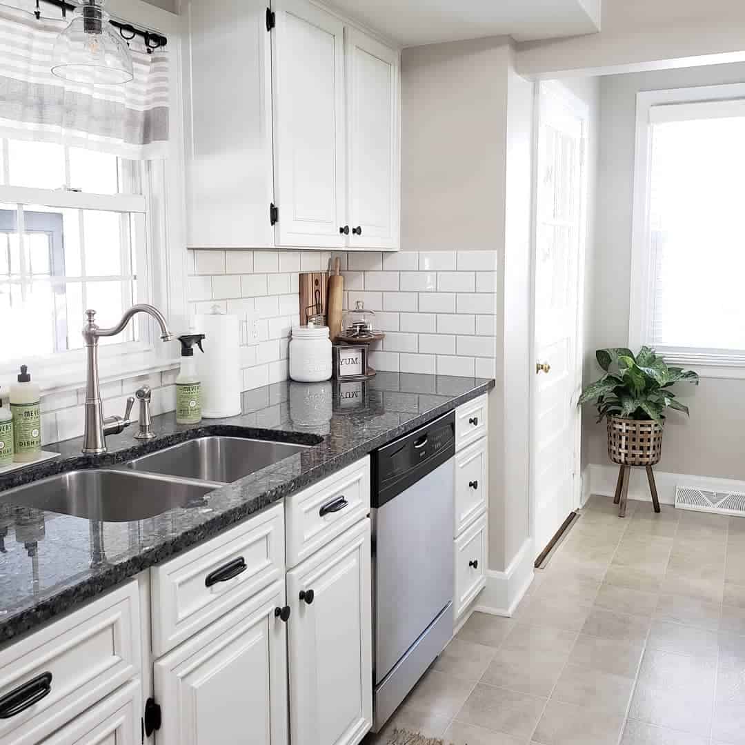 White Subway Tile Backsplash and Black Countertop with Natural Light