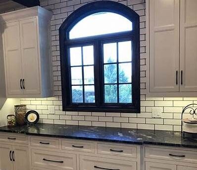 White Subway Tile Kitchen with Textured Black Marble Countertop
